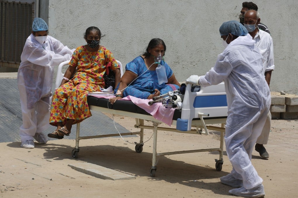 Health workers move Covid-19 patients to a new hospital to make space for new cases, as India battles a surge in coronavirus infections. Photo: AP