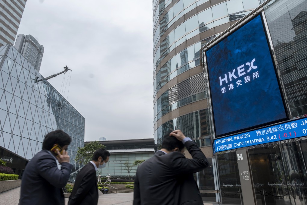 Pedestrians walk past the Exchange Square complex which houses the Hong Kong Stock Exchange, on March 23. Instead of a stamp duty increase, the government should look at tightening listing regulations. Photo: Bloomberg