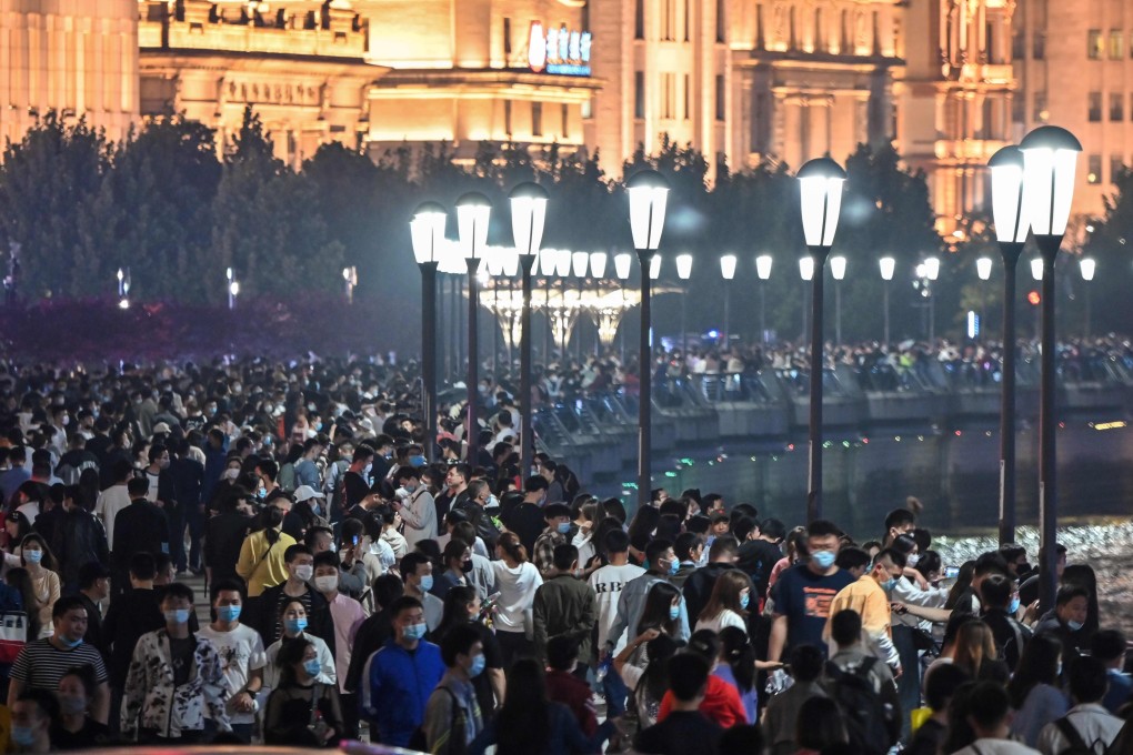 Large crowd of people on tThe Bund along the Huangpu River in Shanghai, China’s premier commercial hub and one of the country’s largest megapolises, with a population of 25 million residents, on May 1, 2020. Photo: AFP