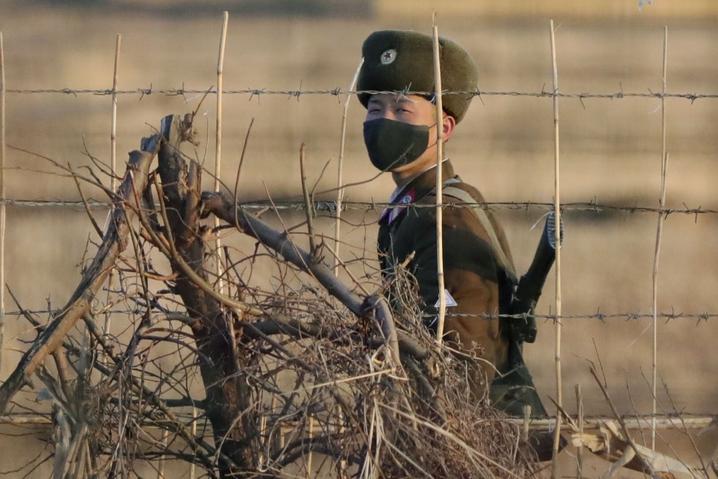 Photo taken from Dandong, China, of a North Korean soldier patrolling the border with China. Photo: Kyodo