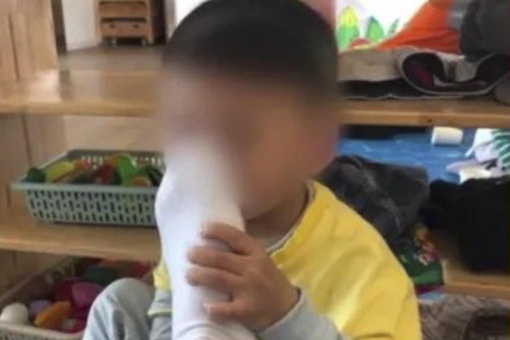 A kindergarten teacher in Jiangxi was sacked and detained for a week after posting pictures of himself making a boy smell his foot. Photo: Weibo
