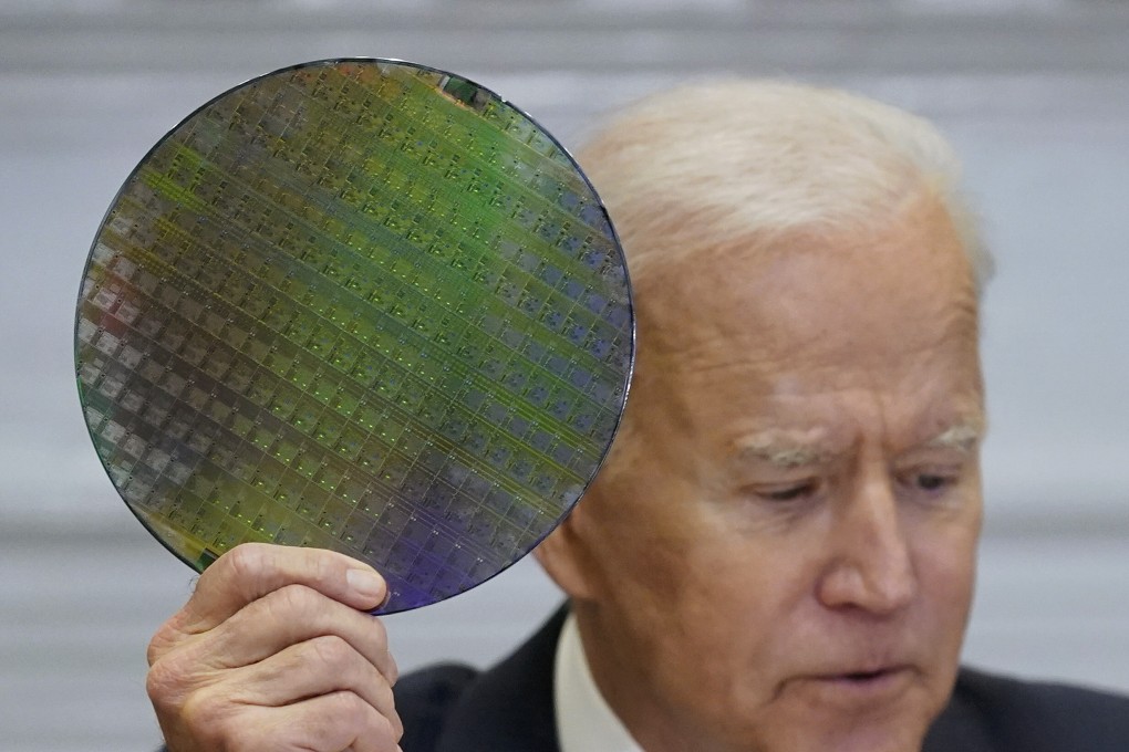 US President Joe Biden holds up a silicon wafer as he participates virtually in the CEO Summit on Semiconductor and Supply Chain Resilience in the White House in Washington on April 12. Photo: AP