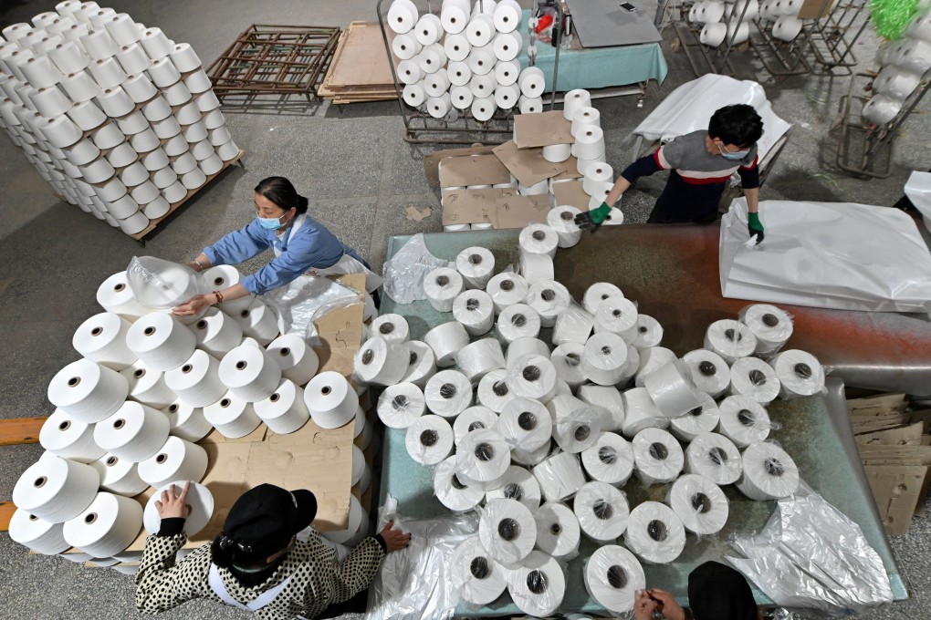 Workers are seen on the production line at a cotton textile factory in Korla, Xinjiang, on April 1. Photo: Reuters