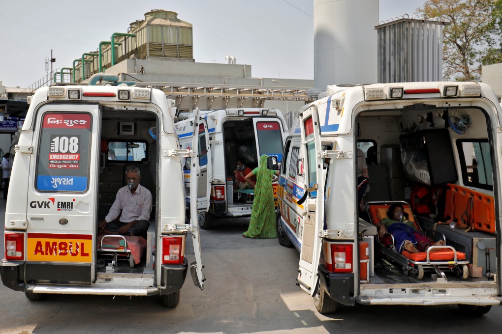 Patients with breathing problems wear oxygen masks as they wait inside ambulances in a queue to enter a Covid-19 hospital in Ahmedabad, India, on April 14. Photo: Reuters