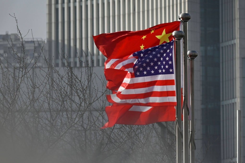 Chinese and US national flags flutter at the entrance of a company office building in Beijing. Photo: AFP