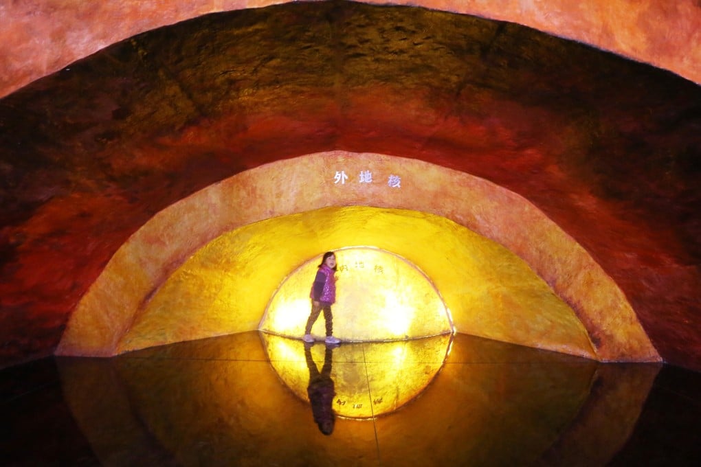 A girl plays in front of a model of the Earth’s inner core at the Geological Museum of Nanjing in China in April 2014. Photo: Xinhua