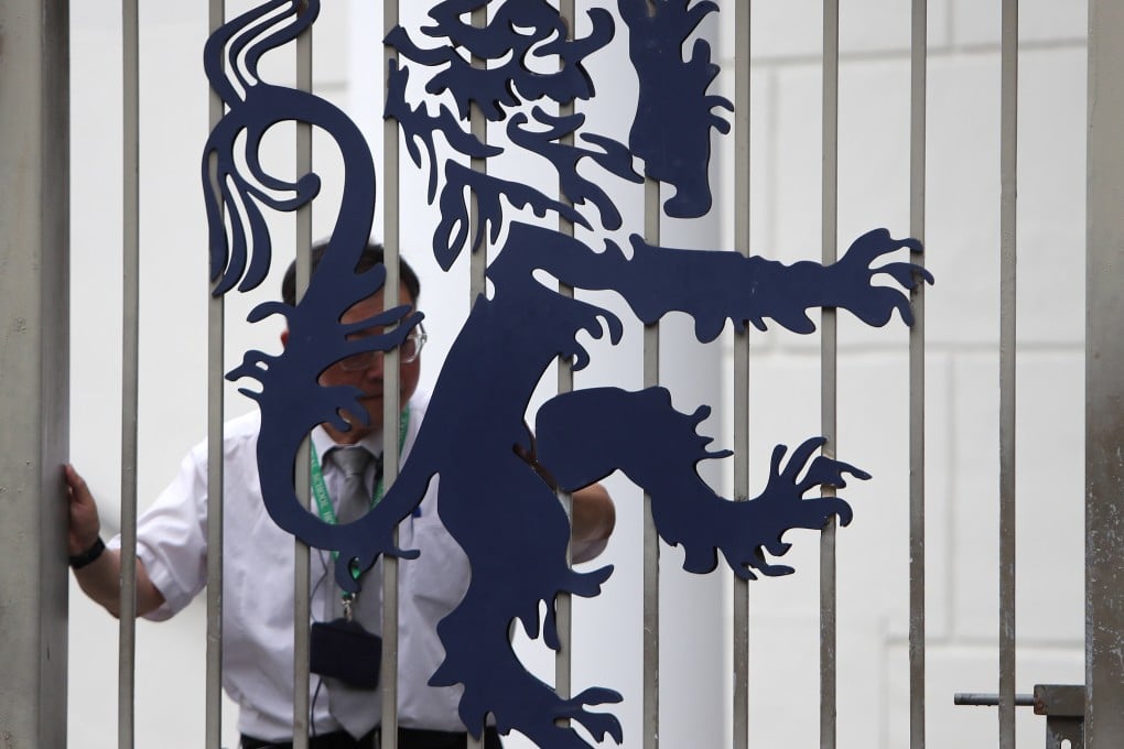 A security guard behind the gates of Harrow International School Hong Kong in Tuen Mun. Photo: Winson Wong