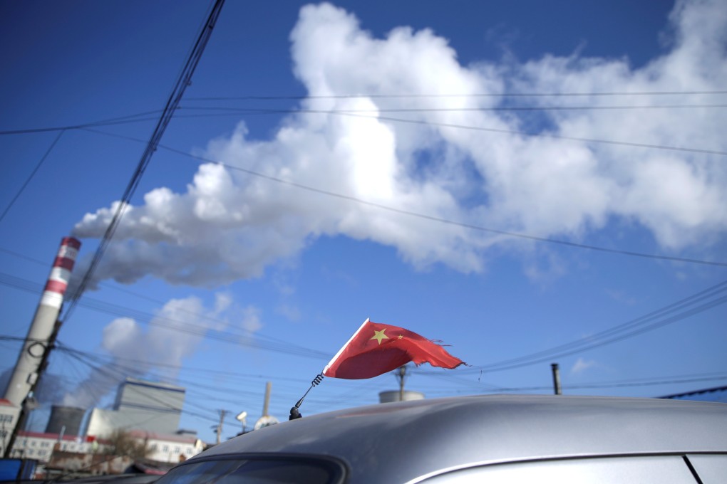 A Chinese flag is seen on top of a car near a coal-fired power plant in Harbin, Heilongjiang province, in November 2019. Last year, China added 38.4GW in new coal-fired power – three times the rest of the world combined. Photo: Reuters