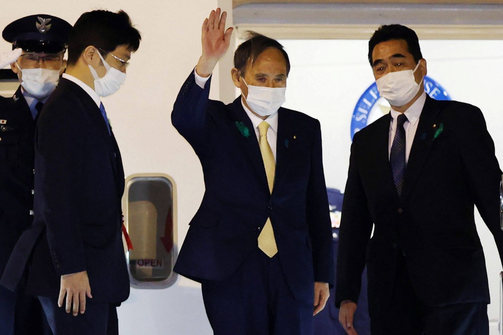 Japan’s Prime Minister Yoshihide Suga waves as he departs for the US from Tokyo’s Haneda airport on Thursday. Photo: STR via AFP