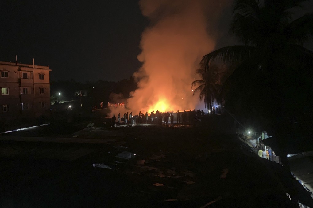 Flames rise from a fire in a makeshift market near a Rohingya refugee camp in Bangladesh on April 2. Photo: AP