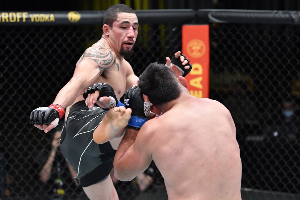 Robert Whittakerkicks Kelvin Gastelum in their middleweight fight. Photos: Chris Unger/Zuffa LLC
