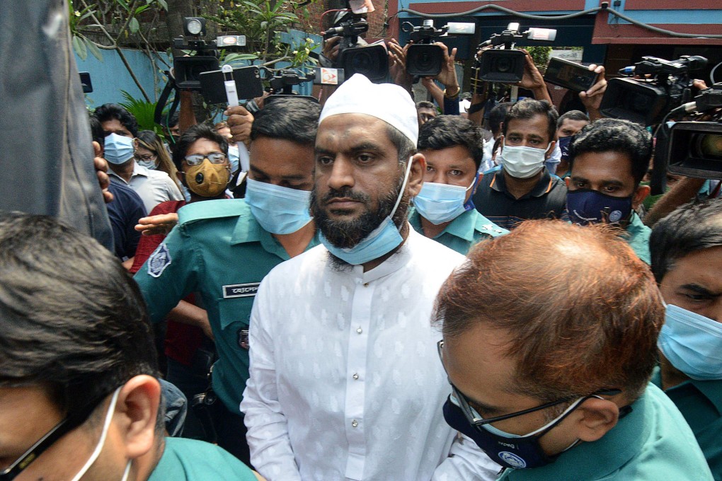Police escort Mamunul Haque, a joint secretary of hardline Islamist group Hefazat-e-Islam, following his arrest in Dhaka on April 18. Photo: AFP