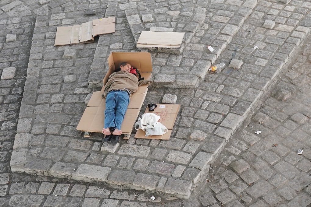 A street sleeper in Hong Kong’s Sheung Wan district lies on cardboard, on July 25 last year. Photo: Felix Wong