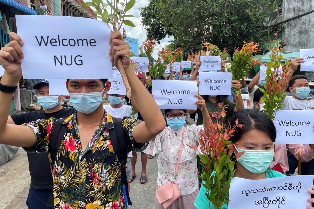 Anti-government protesters in Yangon hold placards to show their support for the new National Unity Government found by ousted NLD legislators. Photo: Reuters