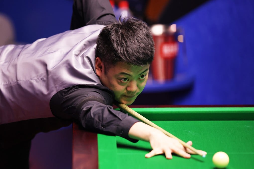 Liang Wenbo plays a shot during his Betfred World Snooker Championship round one match against Neil Robertson. Photo: George Wood/Getty Images