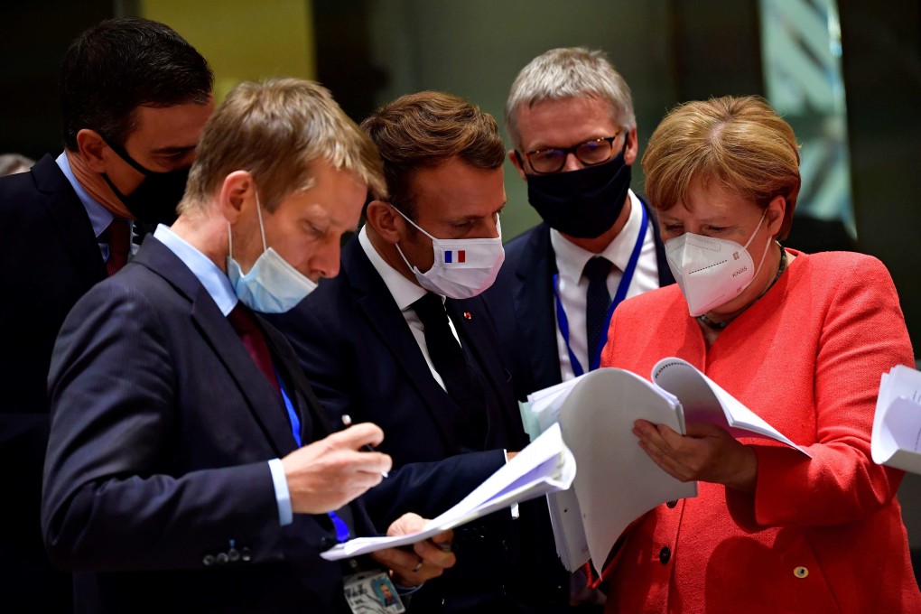 Spanish Prime Minister Pedro Sanchez (left), French President Emmanuel Macron (centre) and German Chancellor Angela Merkel (right) examine documents during an EU summit in Brussels last July. Photo: AFP