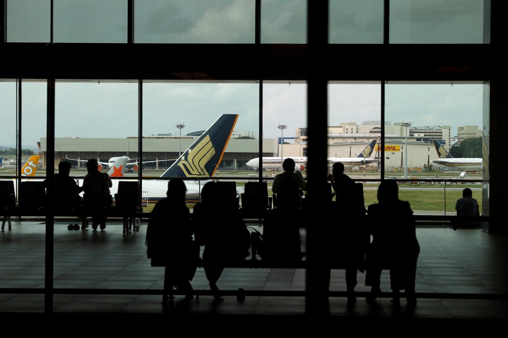 People look at a Singapore Airlines plane while in Changi Airport. Photo: Reuters