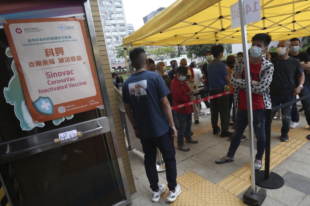 People wait to get the Sinovac vaccine at Kowloon Bay Sports Centre. Photo: Jonathan Wong