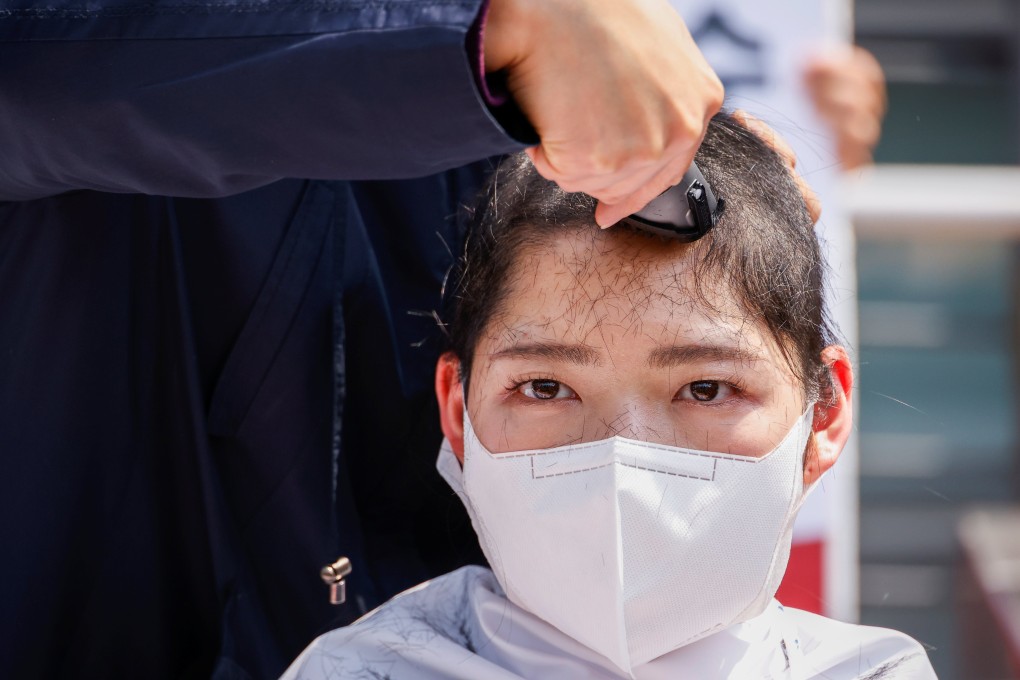 A South Korean university student gets her head shaved during a protest against Japan’s decision to release contaminated water from its crippled Fukushima nuclear plant into the sea, in front of the Japanese embassy, in Seoul, South Korea, on April 20. Photo: Reuters