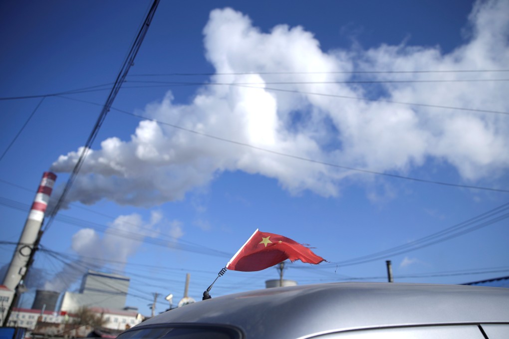 A Chinese flag is seen on the top of a car near a coal-fired power plant in Harbin, Heilongjiang province, in November 2019. To smooth the way for international investors to enter China’s green finance market, the PBOC this year revised issuance guidelines to remove “clean utilisation of fossil fuels” from the list of projects that can qualify as “green”. Photo: Reuters