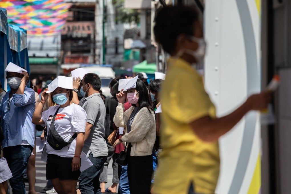 People stand in line for a swab test at a temporary Covid-19 testing site in Bangkok on Monday. Photo: Bloomberg