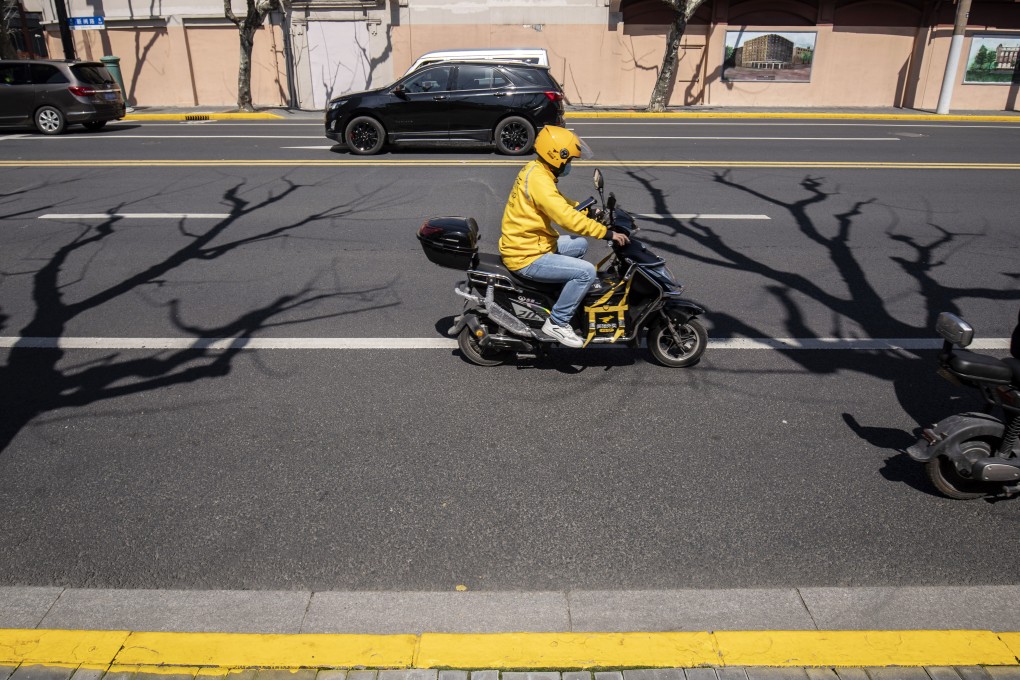 A delivery courier for Meituan travels along a road in Shanghai. Photo: Bloomberg