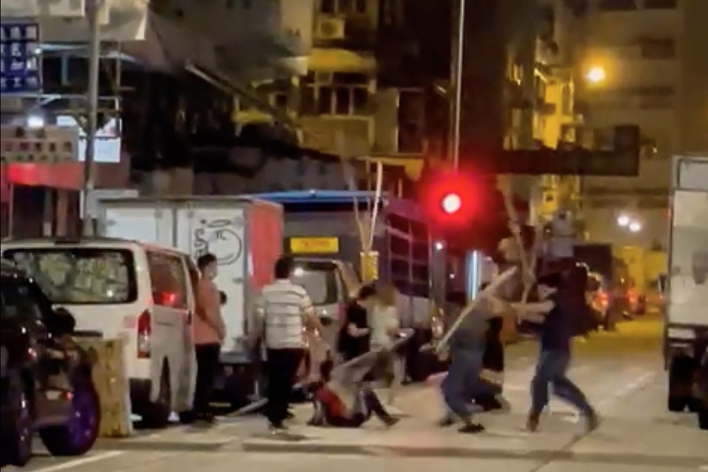 A still from an online video shows a gang of attackers beating two victims with bamboo poles in the early hours of Wednesday in Sham Shui Po. Photo: Handout