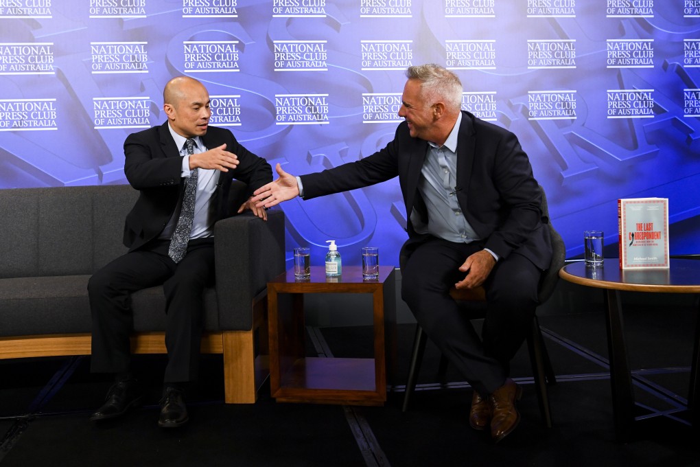 Wang Xining, left, the Chinese embassy in Australia’s deputy head of mission, shakes hands with Michael Smith, one of the last journalists working for Australian media to leave China, at an event in Canberra on April 21. Photo: AP