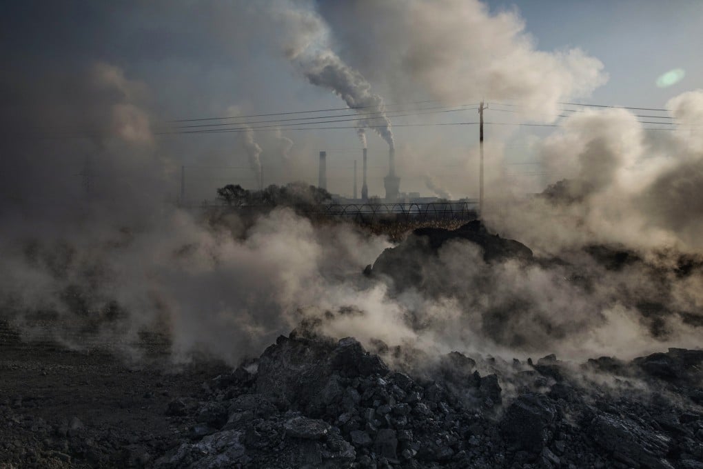 Steam and smoke from waste coal and stone rises after being dumped next to an unauthorized steel factory in Inner Mongolia, China. Photo: Getty Images