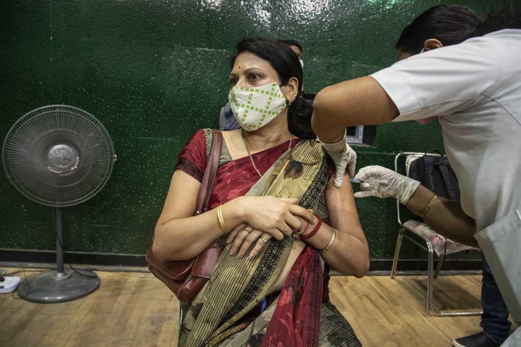 A woman receives a Covid-19 vaccine at an indoor stadium in Gauhati, India on Thursday. Photo: AP