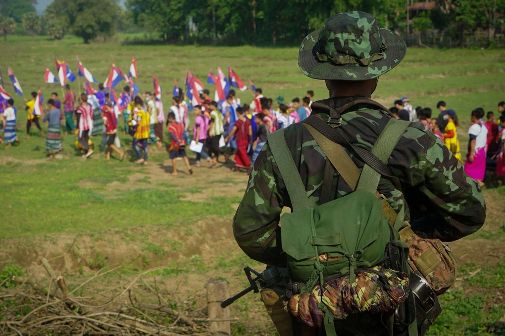 An armed rebel provides security during a demonstration against the military coup in Myanmar. Photo: AFP