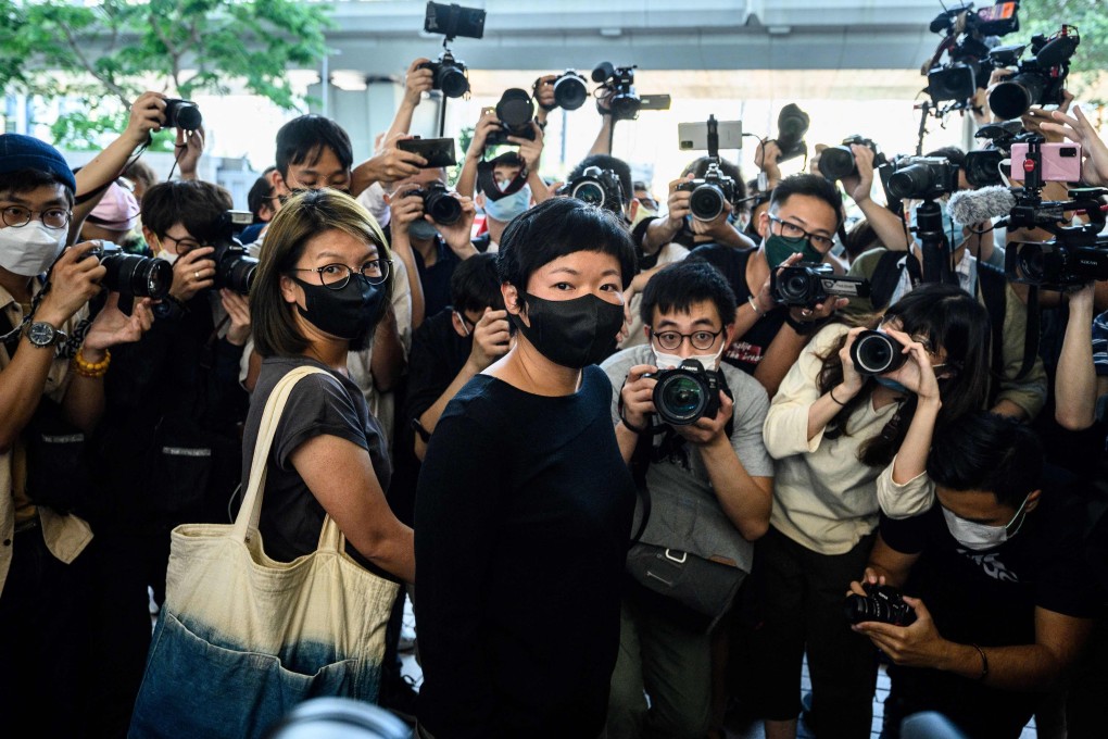 RTHK producer Bao Choy surrounded by members of the press after being found guilty of improperly searching a public vehicle licence database. Photo: AFP