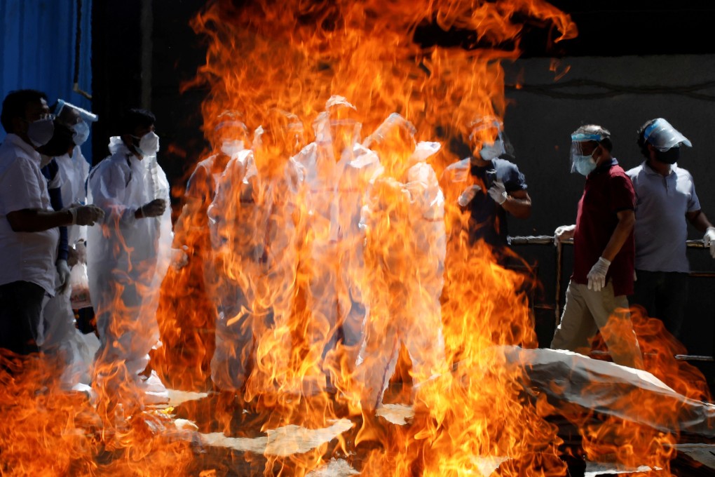 A funeral service is held in New Delhi as the number of cases in the country continues to rise. Photo: Reuters