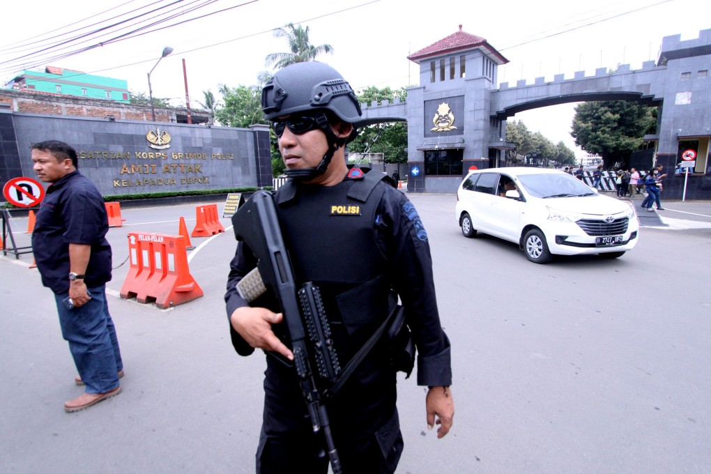 A police officer stands guard outside the Mobile Police Brigade headquarters. Photo: Reuters