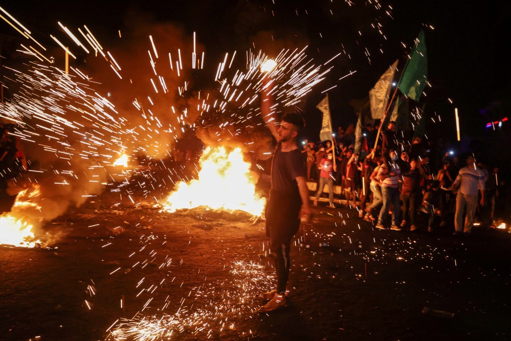 A Palestinian swirls homemade sparkler fireworks during an anti-Israel protest in Gaza City on Saturday. Photo: Reuters
