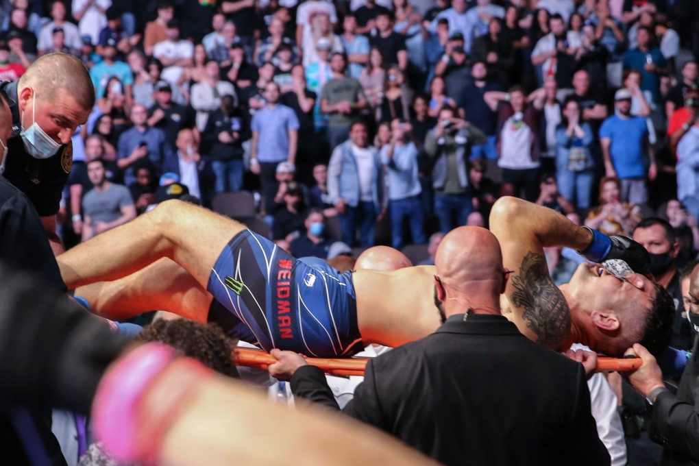 Chris Weidman is stretchered out after breaking his leg against Uriah Hall at UFC 261. Photo: AFP