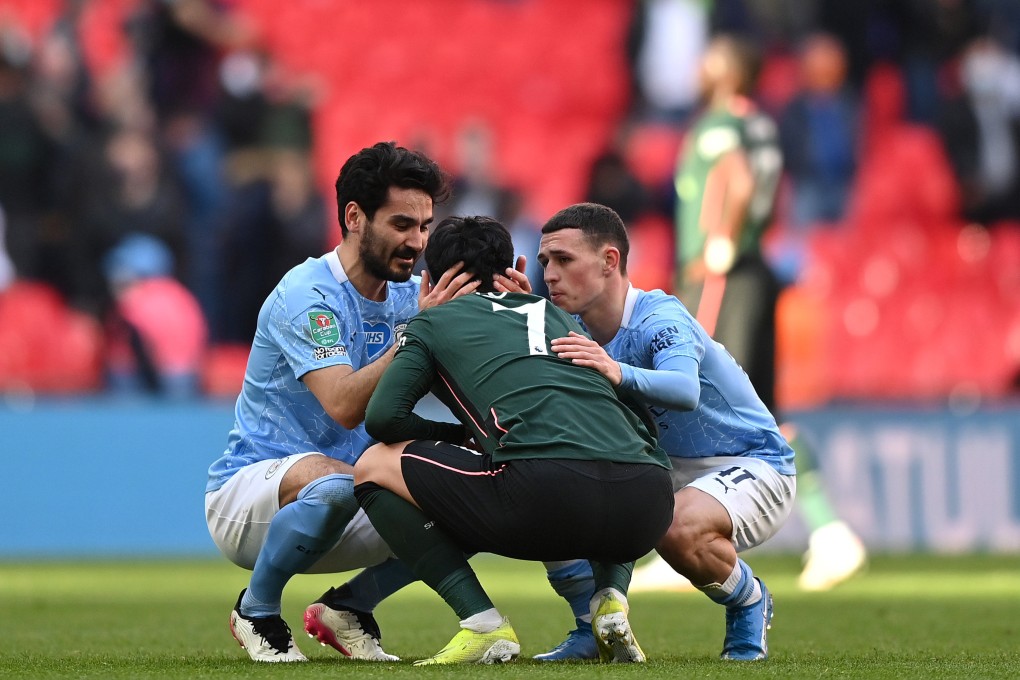 Son Heung-min of Tottenham Hotspur is consoled by Ilkay Gundogan and Phil Foden of Manchester City after the Carabao Cup Final at Wembley Stadium. Photo: Tottenham Hotspur FC via Getty Images