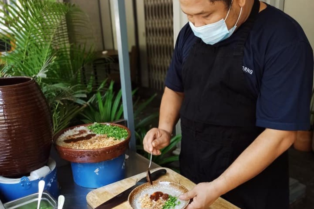 Chef Orng Joitamoi makes congee outside his restaurant which he had to close due to loss of business as a result of the military coup and coronavirus pandemic. Photo: Facebook