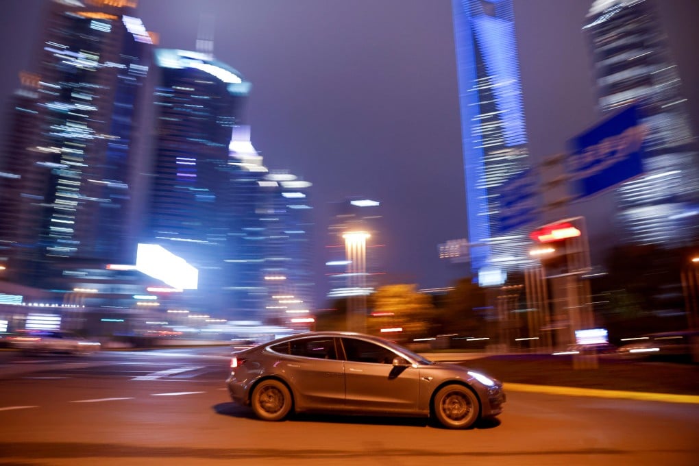 A Tesla electric vehicle (EV) speeding across a street in Shanghai on March 9, 2021. Photo: Reuters