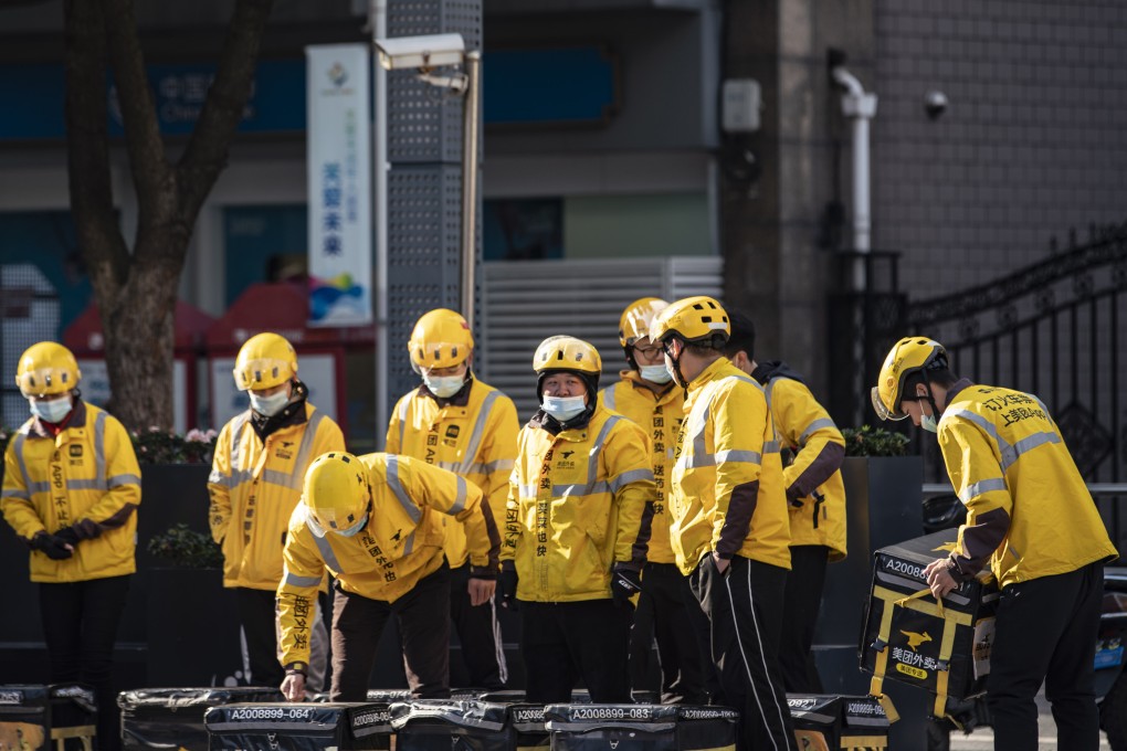 Food delivery couriers for Meituan stand with insulated bags during a morning briefing on a street in Shanghai on Sunday, Nov. 29, 2020.Photo: Bloomberg
