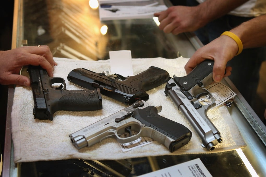 Customers shop for a gun at a store in Illinois. File photo: AFP