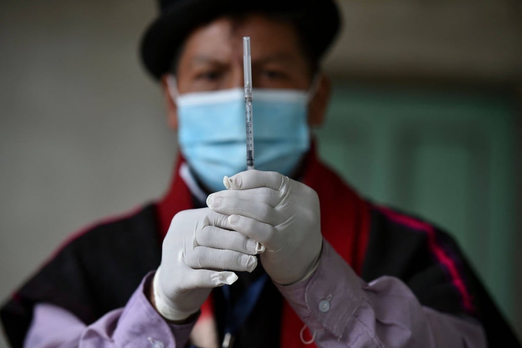 An Indigenous nurse of the Misak ethnic group prepares a dose of the Sinovac vaccine in rural Colombia. Photo: AFP