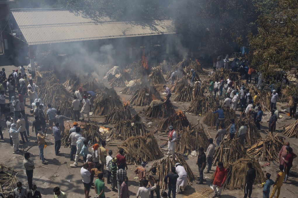 Funeral pyres are lit for Covid-19 victims at a temporary crematorium in New Delhi. Photo: AP
