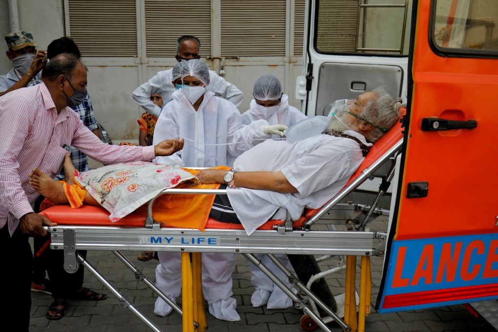 A patient wearing an oxygen mask is wheeled inside a Covid-19 hospital for treatment in Ahmedabad. Photo: Reuters