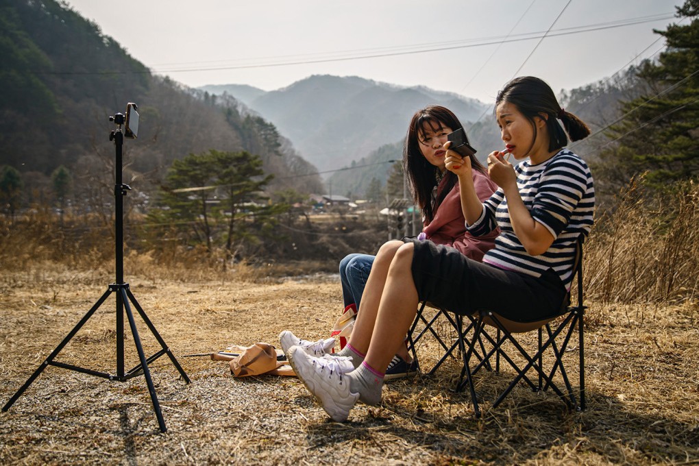 Seok Hyeon-ju (right) reapplies her lipstick before filming a YouTube video with fellow North Korean refugee YouTuber Sim Ha-yoon. They are part of a growing number of North Korean refugees telling their stories of escape and survival on YouTube. Photo: TNS