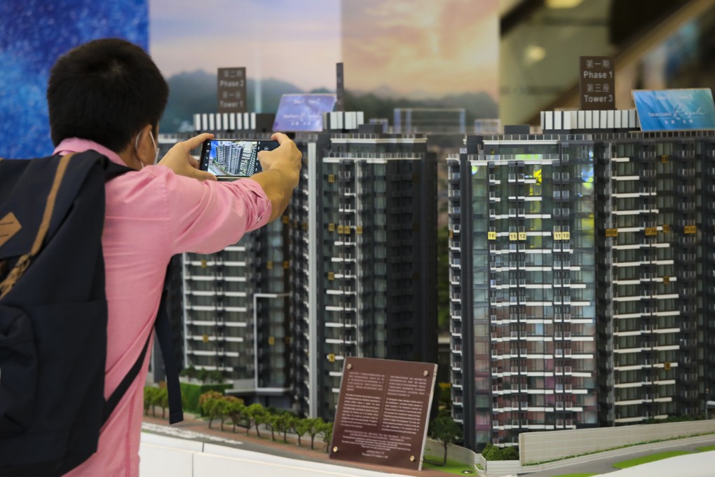 Potential buyers at a property sales office in Hong Kong. Property transactions have soared this year thanks to low interest rates and demand from new immigrants. Photo: K Y Cheng