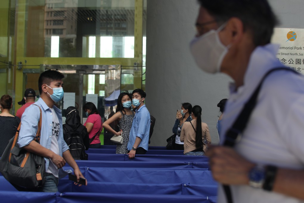 Hong Kong residents queue up for BioNTech vaccinations at Sun Yat Sen Memorial Park Sports Centre in Sai Ying Pun. Photo: Xiaomei Chen
