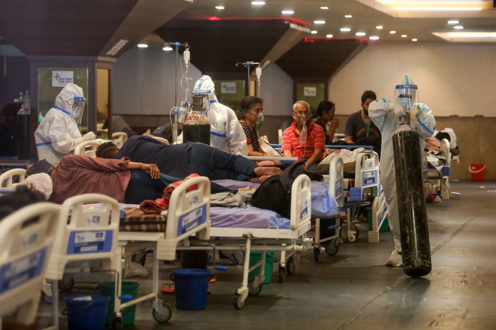 Indian health care workers in personal protective equipment (PPE) care to Covid-19 patients in an isolation ward installed temporarily in a banquet hall in New Delhi. Photo: DPA