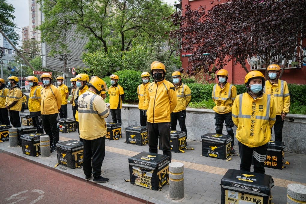 Food delivery couriers for Meituan during a morning briefing in Beijing. Photo: Bloomberg