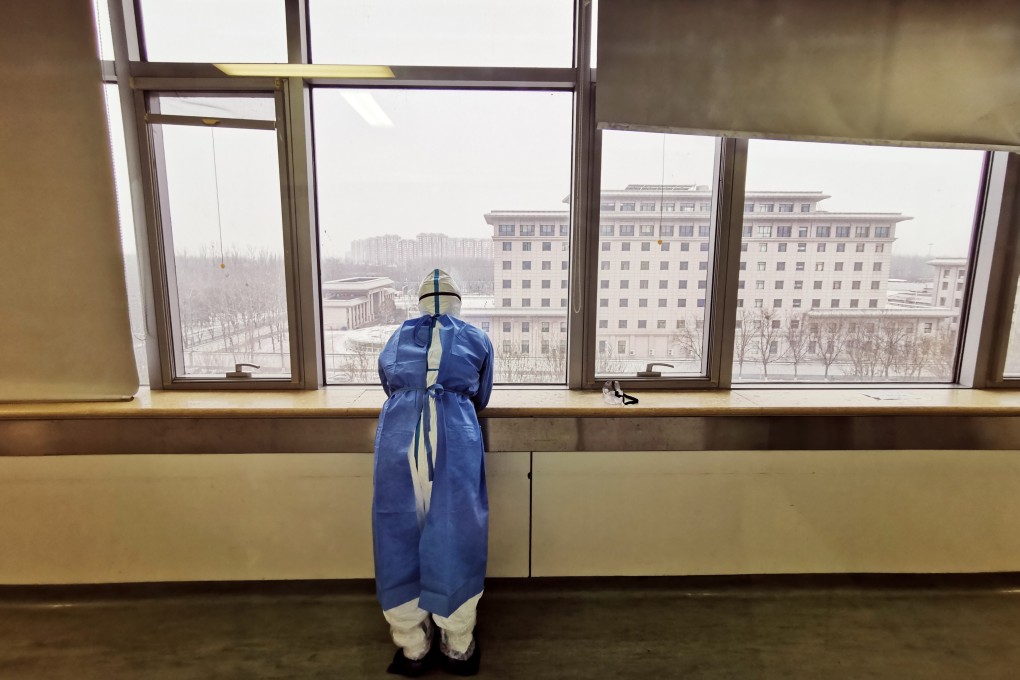 A frontline medical worker looks out a window at a Wuhan hospital during the lockdown triggered by Covid-19 in 2020 in this still from the documentary Wuhan Wuhan.